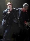 U2 singer lead singer Bono, left, leans on the shoulder of bassist Adam Clayton during the first concert of their Vertigo Tour at the San Diego Sports Arena Monday, March 28, 2005. (AP Photo/Denis Poroy)