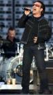 Bono, lead singer of Irish rock band U2, and drummer Larry Mullen (L) perform during a concert at the King Baudouin Stadium in Brussels June 10, 2005. U2 is currently on their 'Vertigo 2005' world tour with Brussels as the first concert in Europe. REUTERS/Str