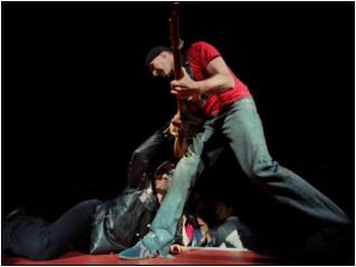 Bono, on floor, and the Edge cavort during U2's performance, the first of three sold-out Anaheim shows. (photo FRANCINE ORR / Los Angeles Times)