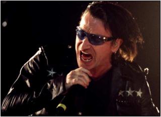 Bono sings at the Arrowhead Pond in Anaheim: U2 dedicated one of its songs, 'In a Little While,' to the late Joey Ramone and also sang one of the Ramones' songs. (photo FRANCINE ORR / Los Angeles Times)