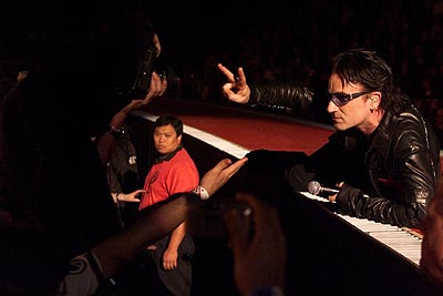 U2 lead singer Bono gives the peace sign on stage at the Air Canada Centre during the band's Elevation Tour 2001 in Toronto, Thursday, May 24, 2001; Photo: Greg Henkenhaf, SUN <br />