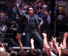 Lead singer and sometimes guitarist Bono does a little jig for the crowds at the June 5 Fleetcenter show. (AP Photo)