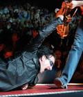 U2's frontman Bono, reaches up for The Edge's guitar as he lies on the stage during a performance at New York's Madison Square Garden Sunday, June 17, 2001. (AP Photo/Chad Rachman)