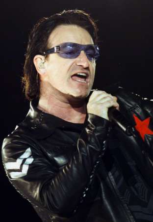 Bono, lead singer for the rock group "U2," performs during a concert in New York's Madison Square Garden, June 17, 2001. The band is nearing the end of it's North American tour and will be starting a European swing in early July. REUTERS/Jeff Christensen