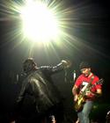 The Edge, right, performs with Bono during the U2 concert at Continental Airlines Arena Friday, June 22, 2001, in East Rutherford, N.J. the show was the last performance of the North American leg of the 2001 Elevation tour. (AP Photo/Bill Kostroun)