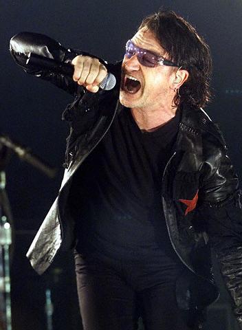 U2 lead singer Bono performs during a concert in Barcelona on August 8, 2001. The Irish band is touring Spain during their "Elevation" tour. REUTERS/Albert Gea 