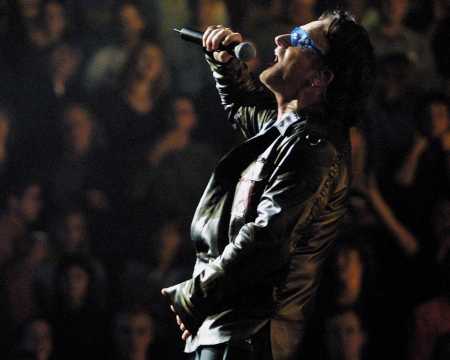 Bono, lead singer of U2, sings during their Elevation Tour 2001 at the Molson Center in Montreal, Quebec Friday Oct. 12, 2001. (AP Photo/CP, Andre Forget)