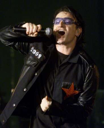 Bono of the group U2 performs at the Baltimore Arena in Baltimore October 19, 2001. Bono will be one of many performers at the "Concert for New York City" to be held in New York on October 20. REUTERS/Molly Riley