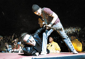 DELTA CENTER JAM Frontman Bono and guitarist the Edge get down during an emotional "Until the End of the World" at U2's Elevation Tour concert stop at the Delta Center on Friday night. A sold-out crowd filled the downtown venue. (Rick Egan/The Salt Lake Tribune) 