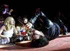 U2 singer Bono rolls around on a catwalk as he sings during a sold-out stop of the band's Elevation Tour at the Thomas & Mack Center in Las Vegas November 18, 2001. The band is touring to support the album 