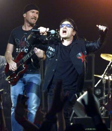 U2 band members, "The Edge" (L) and "Bono," perform in Miami during the pop group's final concert in their "Elevation Tour" December 2, 2001. U2 performed 113 concerts in their run through North America. REUTERS/Colin Braley