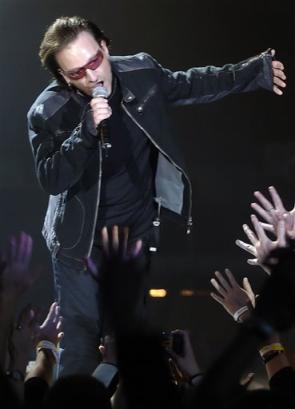 Fans reach out as U2 lead singer Bono performs during the first concert of their Vertigo Tour at the San Diego Sports Arena Monday, March 28, 2005. (AP Photo/Denis Poroy) 