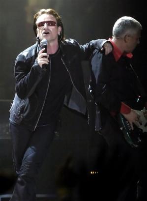 U2 singer lead singer Bono, left, leans on the shoulder of bassist Adam Clayton during the first concert of their Vertigo Tour at the San Diego Sports Arena Monday, March 28, 2005. (AP Photo/Denis Poroy)