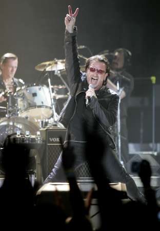 Lead singer Bono and drummer Larry Mullen (L) of the Irish rock group U2 kick off the band's world tour 'Vertigo' with their opening show in San Diego, California March 28, 2005. The Irish rock band has sold over 2.2 million tickets and grossed some $185 million with advance ticket sales. By the time U2's Vertigo concludes, it will be one of the top-grossing rock tours of all time, with a total nearing $300 million . REUTERS/Mike Blake