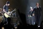U2 drummer Larry Mullen, left, guitarist The Edge, center left, bassist Adam Clayton, center right, and lead singer Bono, right, perform during the first concert of their Vertigo Tour at the San Diego Sports Arena Monday, March 28, 2005. (AP Photo/Denis Poroy) 