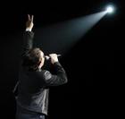 Bono of U2 gestures to the audience during a performace in Los Angeles, Tuesday, April 5, 2005. (AP Photo/Chris Pizzello)