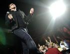 Bono of U2 walks past fans during a concert at the Staples Center in Los Angeles, Tuesday, April 5, 2005. (AP Photo/Chris Pizzello)