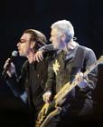 Irish rock group U2's lead singer Bono (L) and bass player Adam Clayton perform at the Staples Center in Los Angeles, California April 6, 2005. U2 began their 'Vertigo' world tour in California. REUTERS/Lee Celano