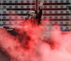 Lead singer Bono of Irish rock band U2 performs during a concert at the City of Manchester Stadium, northern England, June 14, 2005. U2 are currently on their 'Vertigo 2005' world tour. REUTERS/Darren Staples