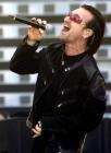 Lead singer Bono, of Irish rock band U2, performs during a concert at the City of Manchester Stadium, June 14, 2005. U2 are currently on their 'Vertigo 2005' world tour. REUTERS/Darren Staples