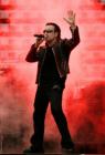 Lead singer Bono of Irish rock band U2 performs during a concert at the City of Manchester Stadium, northern England, June 14, 2005. U2 is currently on their 'Vertigo 2005' world tour. REUTERS/Darren Staples