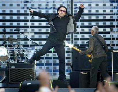 Bono with Irish rock group U2 performs onstage at the City of Manchester Stadium, Manchester Tuesday June 14, 2005.(AP Photo/PA, Gareth Copley)