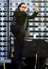 Lead singer Bono, of Irish rock band U2 performs during a concert at the City of Manchester Stadium, June 14, 2005. U2 are currently on their 'Vertigo 2005' world tour. REUTERS/Darren Staples
