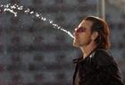 Bono spits water on stage as U2 perform their second song 'I Will Follow' at Croke Park stadium in Dublin, Friday June 24, 2005. ( AP Photo/PA, Haydn West)