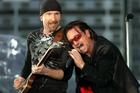 Bono, right, leans on guitarist The Edge as U2 perform their second song 'I Will Follow' at Croke Park stadium in Dublin, Ireland Friday June 24, 2005. (AP Photo/ Haydn West/PA)
