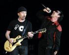 Singer Bono, right, and lead guitarist The Edge of Irish group U2 perform on stage during their Vertigo 2005 Tour at the San Siro stadium in Milan, Italy, Wednesday, July, 20, 2005. (AP Photo/Luca Bruno)