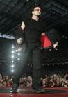 Singer Bono of Irish rock group U2 performs on stage during their Vertigo 2005 Tour at the San Siro stadium in Milan, Italy, Wednesday, July, 20, 2005. (AP Photo/Luca Bruno)