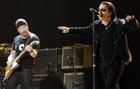 U2's Bono, right, and The Edge perform during the band's concert in Toronto, Monday, Sept. 12, 2005. (AP PHOTO/CP, Aaron Harris)