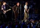 The Edge, left, Bono, center, and Adam Clayton, right, perform during the halftime show of Super Bowl XXXVI at the Louisiana Superdome Sunday, Feb. 3, 2002 in New Orleans. (AP Photo/Tony Gutierrez)