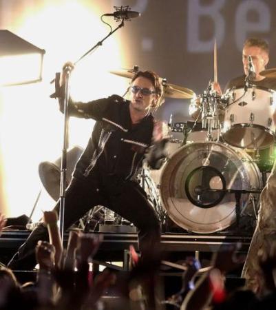 Bono, lead singer of the band U2, performs during halftime of Super Bowl XXXVI at the Louisiana Superdome, Sunday, Feb. 3, 2002, in New Orleans. (AP Photo/Amy Sancetta)