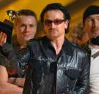 U2's Bono, center, accepts the group's award for best pop performance at the 44th annual Grammy Awards, Wednesday, Feb. 27, 2002, at the Staples Center in Los Angeles. (AP Photo/Kevork Djansezian)