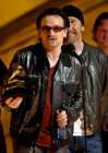 U2's Bono, center, accepts the group's award for best pop performance during the 44th annual Grammy Awards, Wednesday, Feb. 27, 2002, in Los Angeles. (AP Photo/Kevork Djansezian)