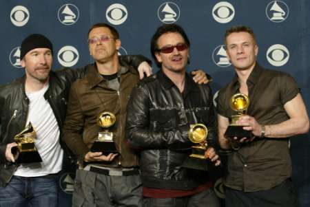 The Irish rock group U2, (L-R) The Edge,Adam Clayton, Bono and Larry Mullen, pose after winning five Grammy Awards, including Record of the Year for "Walk On," Best Rock Performance by a Duo or Group with Vocal for " Elevation" and Best Rock Album for "All That You Can't Leave Behind" at the 44th annual Grammy Awards February 27, 2002 in Los Angeles. REUTERS/Mike Blake