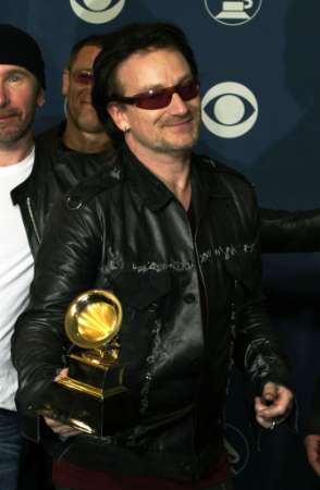 Bono, lead singer of the Irish rock group U2. poses after the group won five Grammy Awards including Record of the Year for "Walk On," Best Rock Performance by a Duo or Group with Vocal for "Elevation" and Best Rock Album for "All That You Can't Leave Behind" at the 44th annual Grammy Awards February 27, 2002 in Los Angeles. REUTERS/Mike Blake