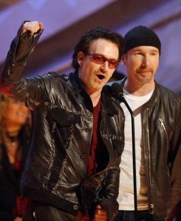 Bono, left, and The Edge, of U2 accept the award for best rock performance by a duo or group for "Elevation" during the 44th annual Grammy Awards, Wednesday, Feb. 27, 2002, in Los Angeles. (AP Photo/Kevork Djansezian)