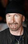 U2 guitarist The Edge poses for photographers as he arrives for the Brit Awards at Earls Court in London February 18, 2009. REUTERS/Luke MacGregor (BRITAIN)
